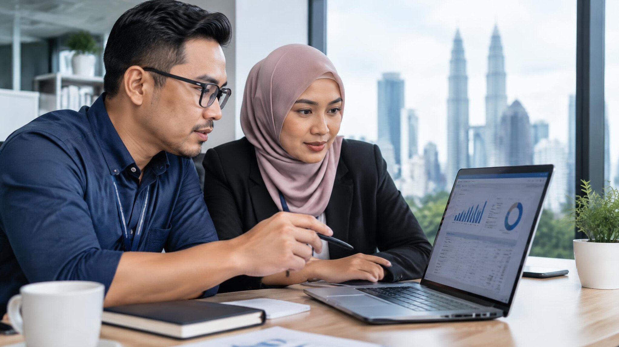 Insurance analysts reviewing digital claims data on a laptop